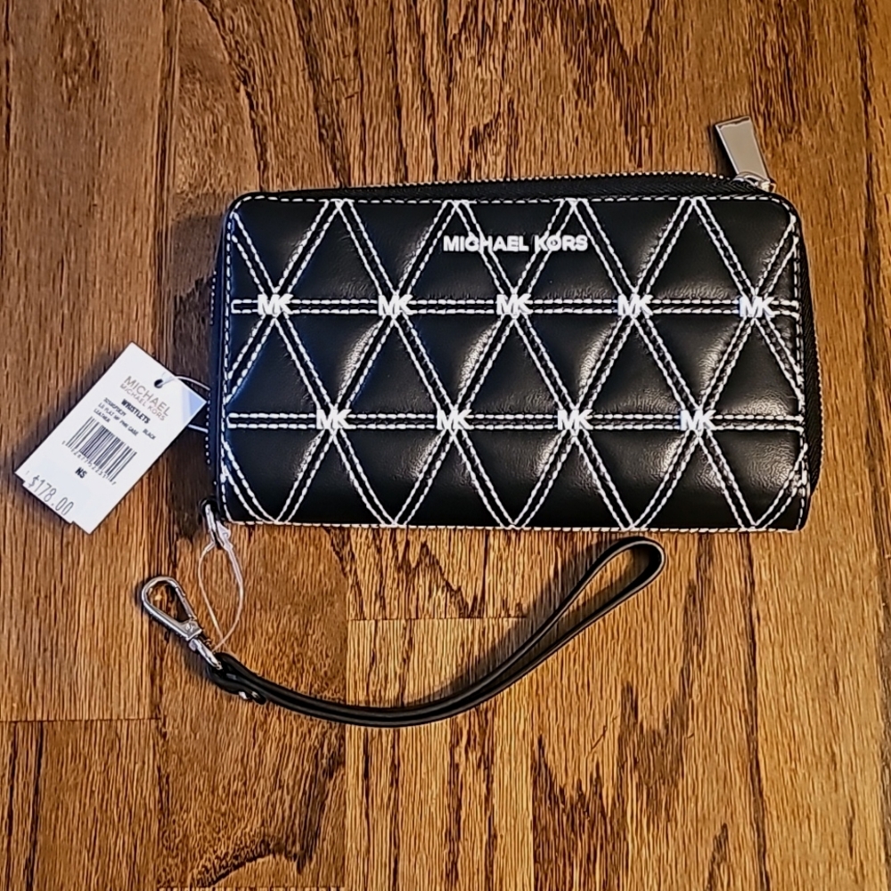 Michael Kors black studded zip around wallet with detachable wristlet strap.